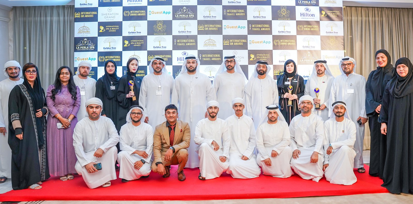 Restaurant and hospitality award winners holding trophies on a red carpet, entrants who test their kitchens against a restaurant prime cost benchmark
